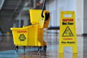 Mop and Bucket with Caution Sign in Commercial Building for Janitorial Service in Doral, FL